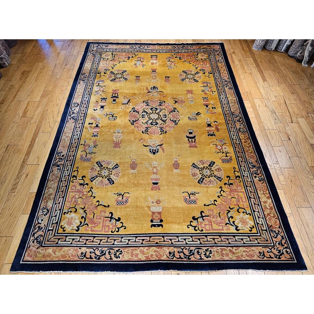 This beautiful Art Deco Chinese rug from the early 20th century showcases a soft, pastel yellow field adorned with...