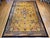 This beautiful Art Deco Chinese rug from the early 20th century showcases a soft, pastel yellow field adorned with...