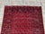 Enhance your living space with this exquisite hand-knotted wool rug, featuring a traditional Bokhara design. The rich red...
