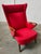 Elegant armchair designed by Chresten Fidahl in Denmark in the 1970s, with red upholstery and wooden armrests. – Vibrant...
