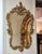 This elegant French Baroque style wall mirror features a richly detailed gold leaf frame with beautifully hand-carved...