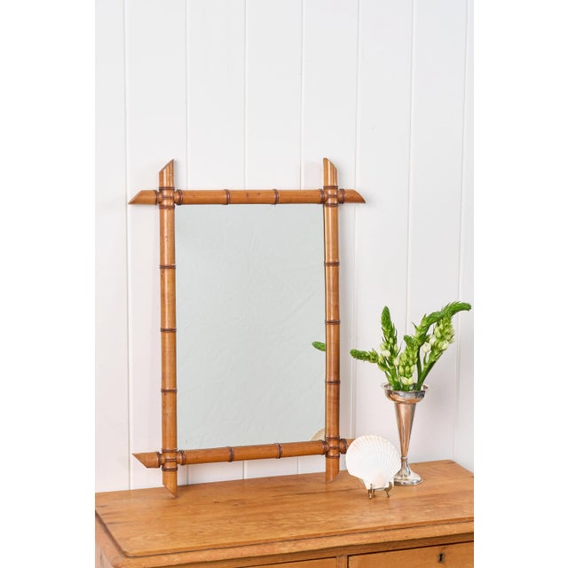 This French bamboo mirror features a warm, honey-toned bamboo frame with pronounced nodes and pegged joints with spear-...