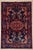 Antique hand-knotted rug from the Nahavand region of western Iran, featuring a bold central medallion on a deep navy...