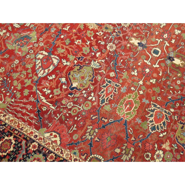 A beautiful highly decorative fine quality room size Heriz rug with all different types of stunning elements including a...