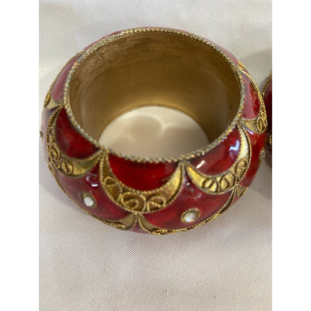 Pretty red napkin rings with gold and sparkle insets. Perfect for a holiday table.