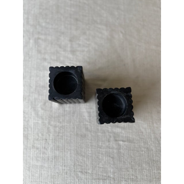 Elevate your tabletop styling with this striking pair of fluted black marble tea light holders. Crafted from solid marble,...