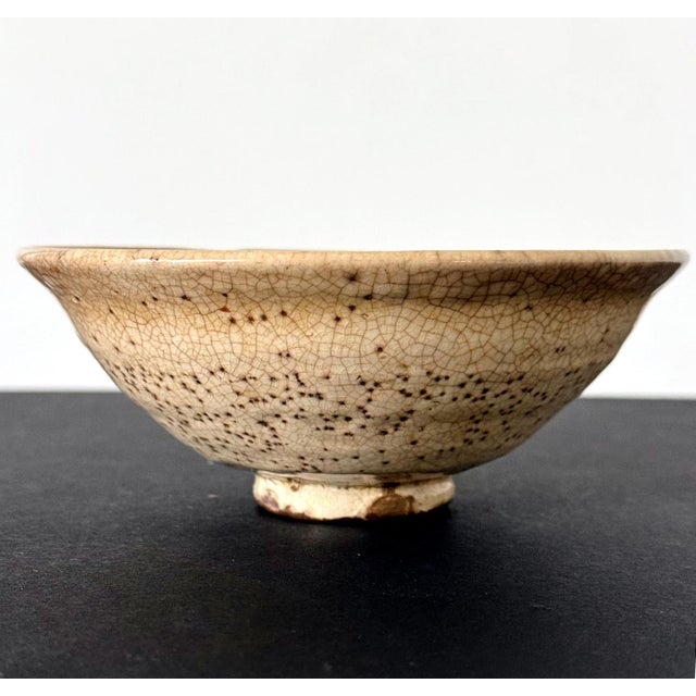 A modern ceramic Chawan (Tea Bowl) by potter Hino Yoshinaga (active post 1940s). Hand-molded and glazed in a white glaze....