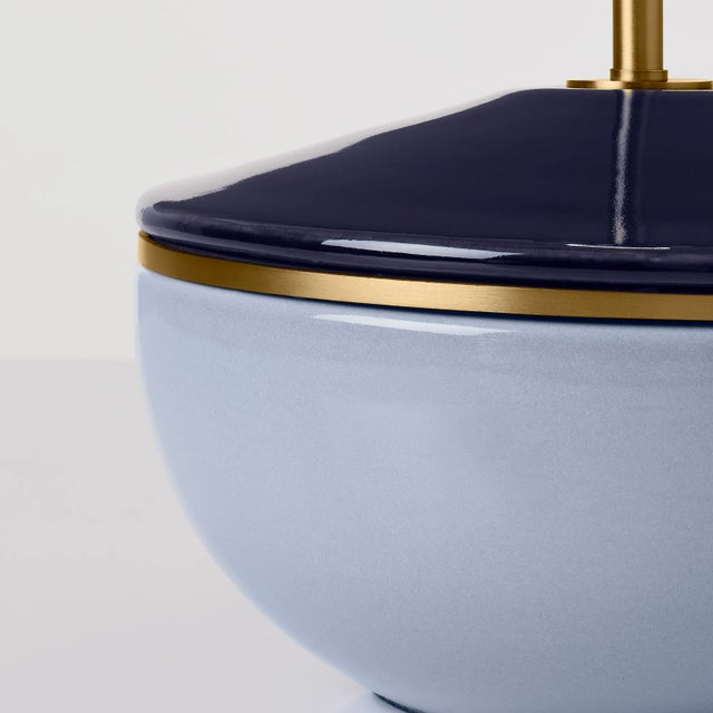 Perfect for bringing color to any room in your home, the Cade table lamp features a dual-painted glass body divided...