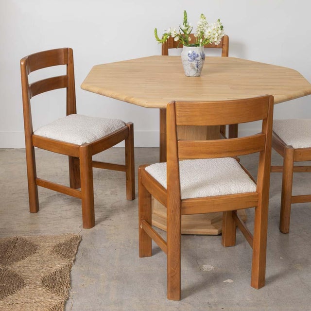 Incredible set of 4 elm wood chairs from France, 1940s. Solid wood frame with curved slatted back. Vintage creamy boucle...