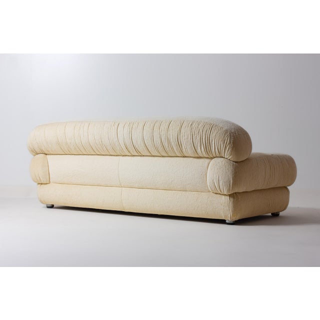 Luxurious Italian three-seater sofa from the 1970s, upholstered in the original soft cream-coloured plush fabric. The sofa...