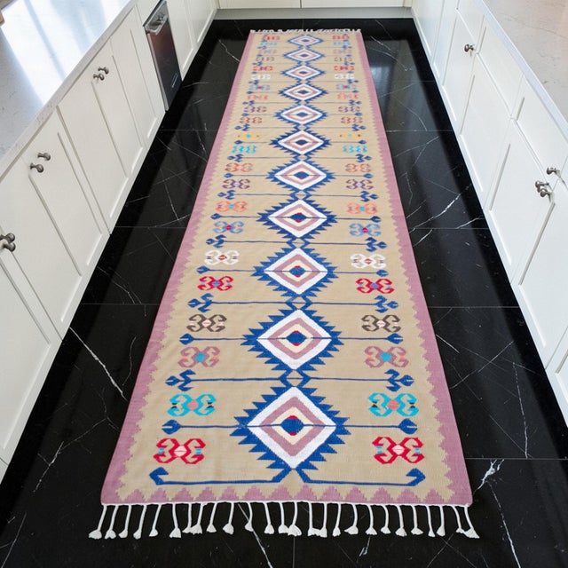 Woven by skilled village artisans in the Aegean region of Turkey, this exceptional extra-long Oushak flatweave runner...