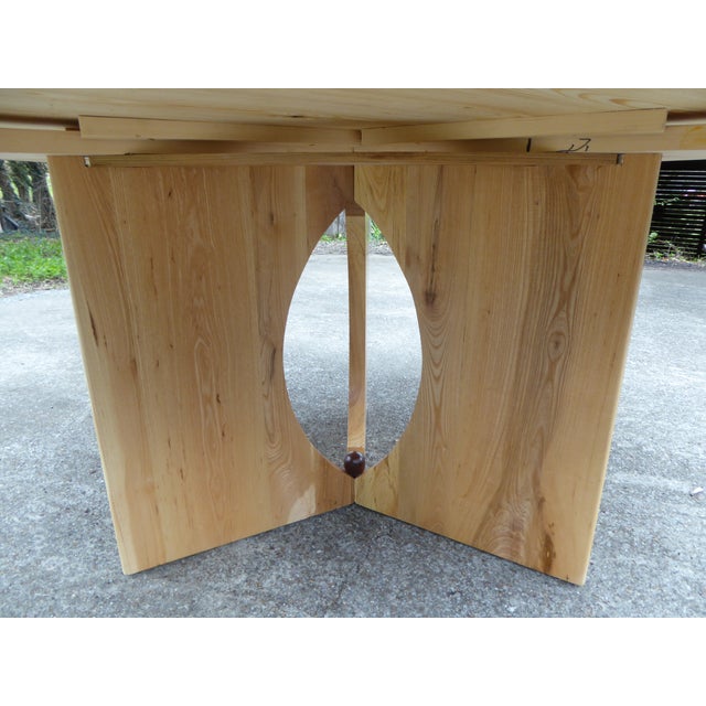 A bespoke dining tbl. in Ash w/h Olive Ash, with walnut accents. A wonderful simplistic design able to seat 8 @ 67'' dia....