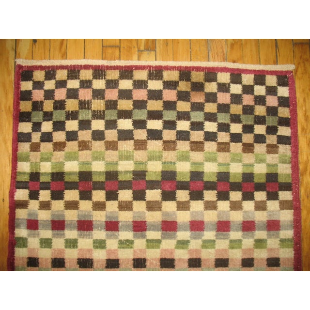 One of a kind, mid 20th-century Hand-knotted Turkish Anatolian Small Size Runner with an all over checkerboard motif....