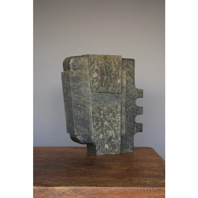 A large basalt stone sculpture composed of simple modernist/architectural forms.At some time this sculpture has stood in a...
