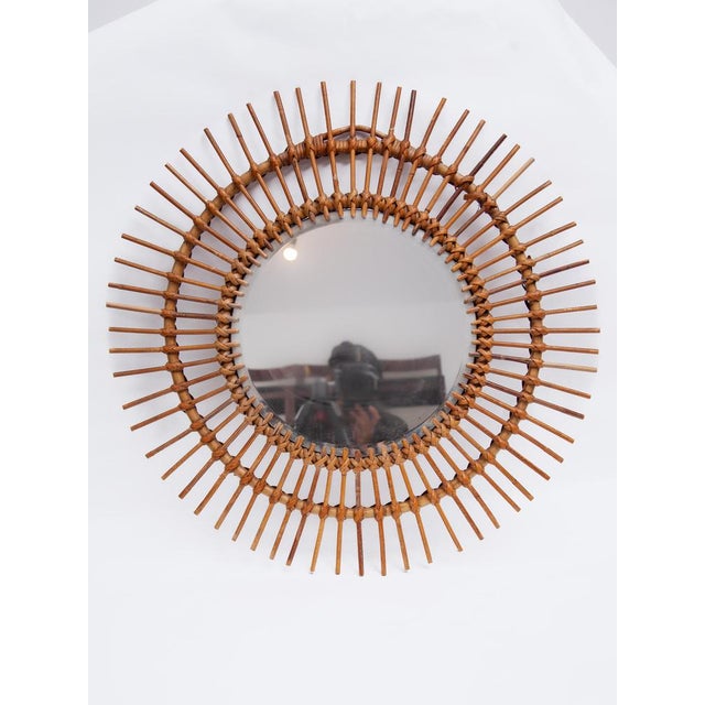 Midcentury French rattan sunburst mirror, 1950s. A vintage collectible classic. The mirror is in good condition with a...