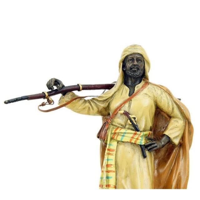 Vienna bronze Arabian warrior sculpture in polychrome bronze, designed as a standing male figure carrying a rifle over his...