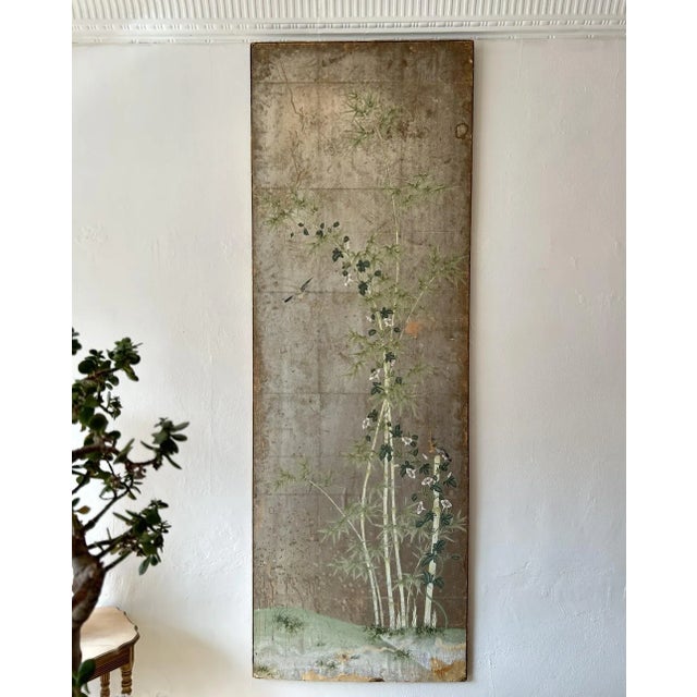 An antique silver Gracie paper panel installed within a giltwood frame. A motif of green bamboo, flowers, and birds on a...