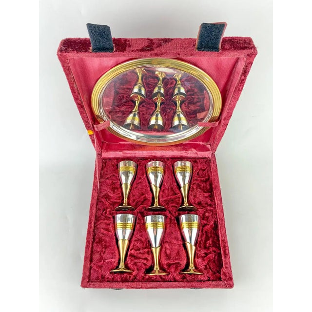 A set of 6 gold and silver plated cordial liquor or spirits glasses, cups to goblets. The set of 6 cups are presented in a...