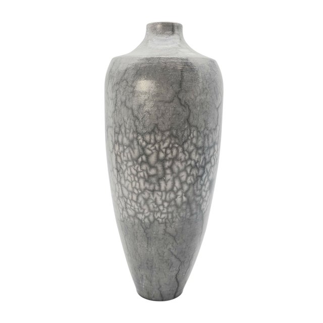 This vase is a breath held in clay and smoke. Its surface wears crackled whispers of bare clay and shadow—an echo of...