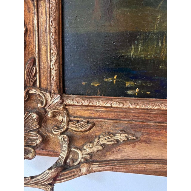 A charming antique oil painting on a solid wood panel. The peaceful pastoral scene features grazing cows beneath a glowing...