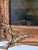 A charming antique oil painting on a solid wood panel. The peaceful pastoral scene features grazing cows beneath a glowing...