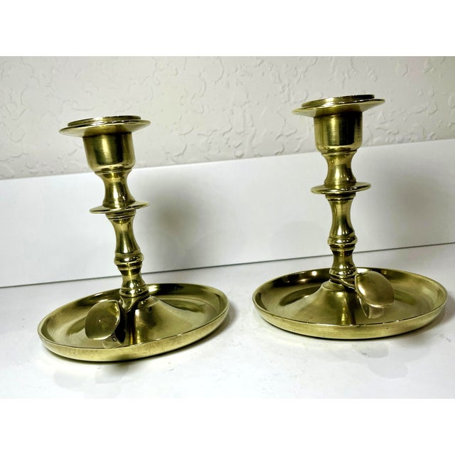 Pair of vintage brass chamberstick candlestick holders. The design is reminiscent of classic 18th century designs...