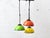 A striking three-light pendant lamp from the 1970s with a characteristic space-age aesthetic. The three hemispherical...