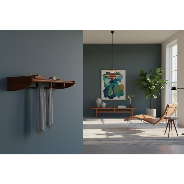 An elegant and very well-made Danish hat rack in solid teak with a timeless design and high functionality. The softly...