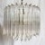 A striking Art Deco two-tier chandelier featuring cascading lucite prisms suspended from a warm brass framework. The...