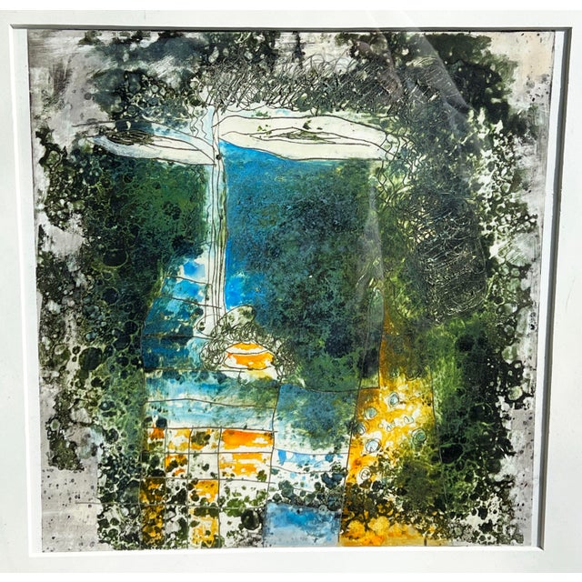 This striking abstract print features organic textures and rich layers of deep greens, blues, and warm golden tones. The...