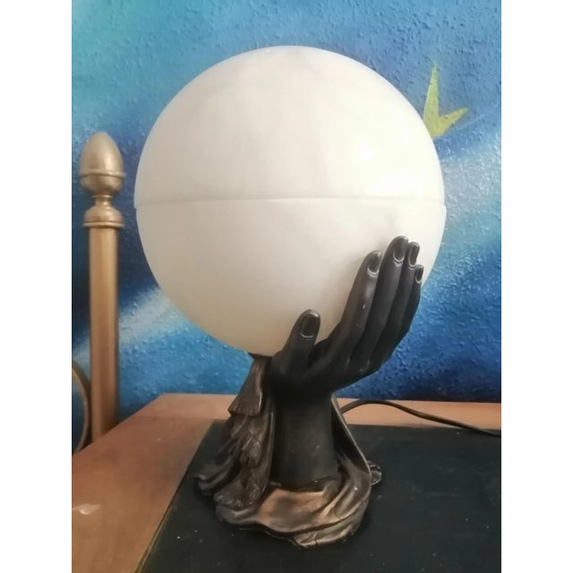 Alabaster lamp in round shape of full moon held by two hands Ntural Alabaster and resin Art Deco style, this sculpture...
