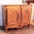 This unusually small cabinet is constructed of warm honey colored elmwood, with its graceful and distinctive attenuated...