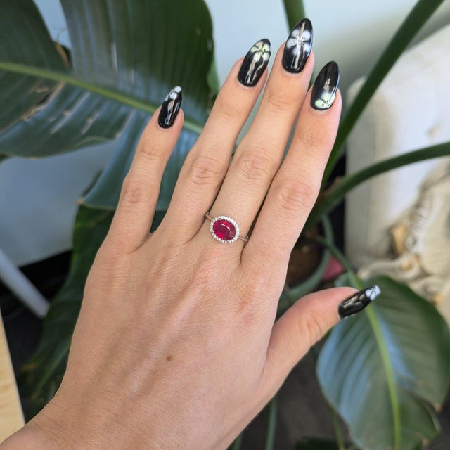 A rich red Madagascar ruby commands this ring, encircled by earth-mined diamonds in solid 14K white gold. The ruby is...