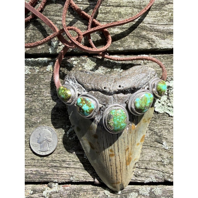 A dramatic statement pendant by Navajo artist Roie Jaque, combining a large fossil megalodon tooth with five substantial...