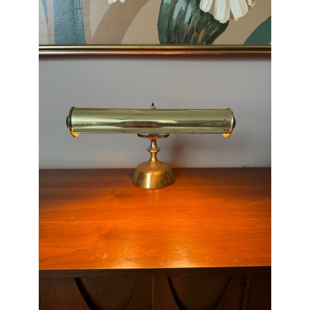 Brass banker’s lamp or desk lamp. The head adjusts up/down and side to side (slightly) and tilts forward/backward, while...