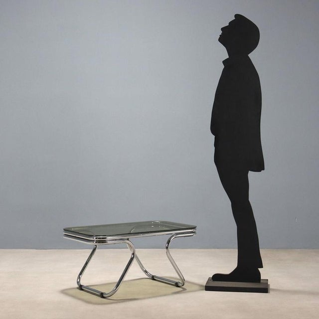 Vintage coffee table with chromed tubular frame and smoked glass top. This piece is attributed to the mentioned...