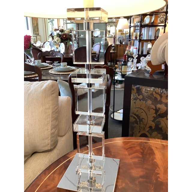 Pair of mid century style crystal block lamps. Stainless base. White shades., Measure 13” h by 14” diameter