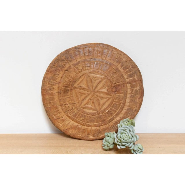 This finely carved vintage chapati plate, handcrafted from wood, brings a touch of global charm to your home. Originally...