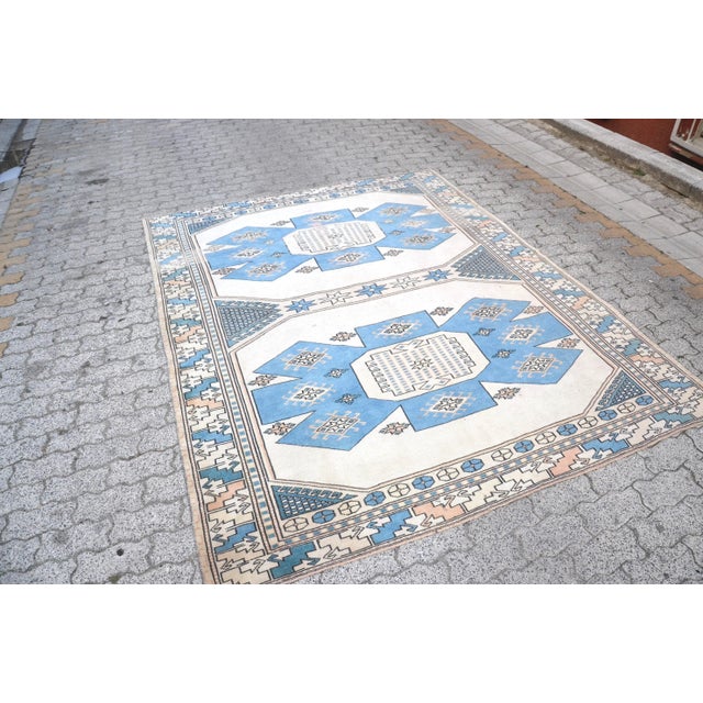 This is a vintage Turkish Oushak rug from the 1960s. The piece was hand-knotted.