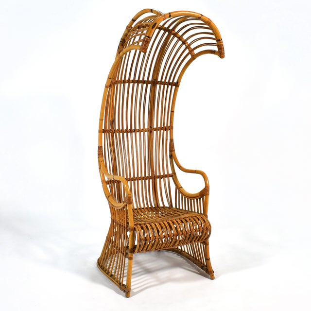 A striking, dramatic design, this vintage rattan canopy or porter's chair has a small footprint, but great visual impact....