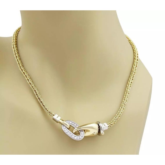 This beautiful necklace is crafted from 18k yellow and white gold with a polished finish. The centerpiece pendant is also...