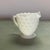 A classic geometric pattern creamer pitcher in translucent milk glass made by the Anchor Hocking Glass Company in...