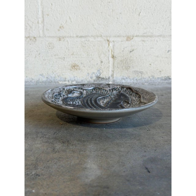 This exceptional mid-century Scandinavian studio ceramic bowl showcases a striking, stylized sgraffito design of a...