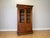 An impressive Antique French bookcase in Oak, featuring two glazed doors, elaborate carved decoration, turned column...