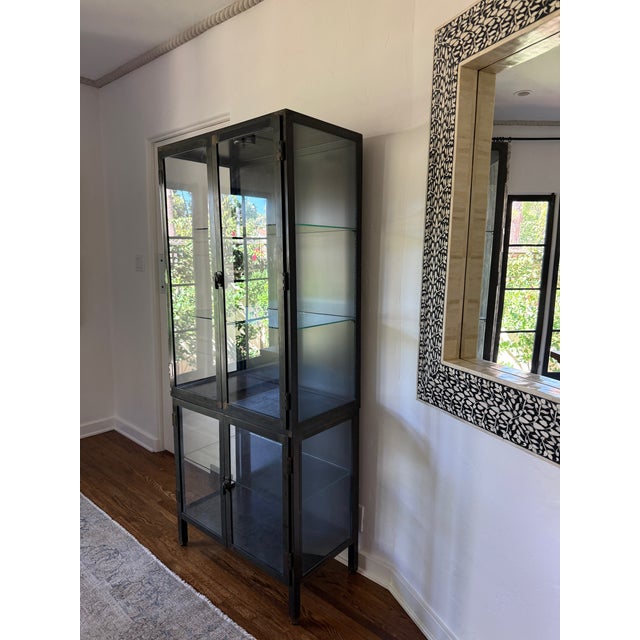 Industrial black iron and glass display cabinet. This is a unique piece for displaying china, dish ware, pottery, books,...