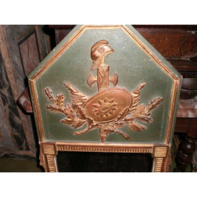Beautifully executed 18th Century French Louis XVI painted and gilt mirror or trumeau mirror with shield design. This...