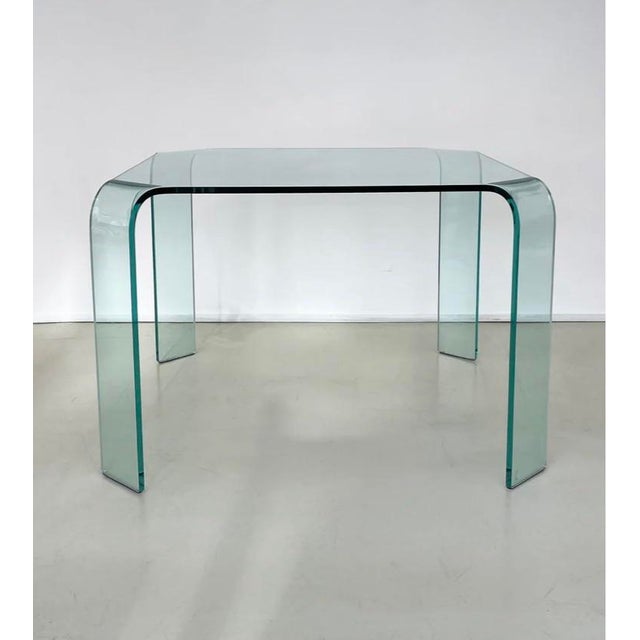 Circa late 1980’s. Solid, one piece “bent” tempered glass dining table. 39x39x28” tall. Seats 4 people. Gorgeous, hard to...