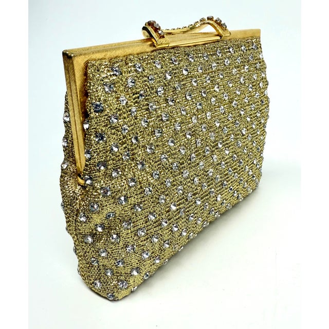 Vintage 1960's era Walborg rhinestone evening bag. The bag is made of metallic gold mesh fabricl with a brushed gold...
