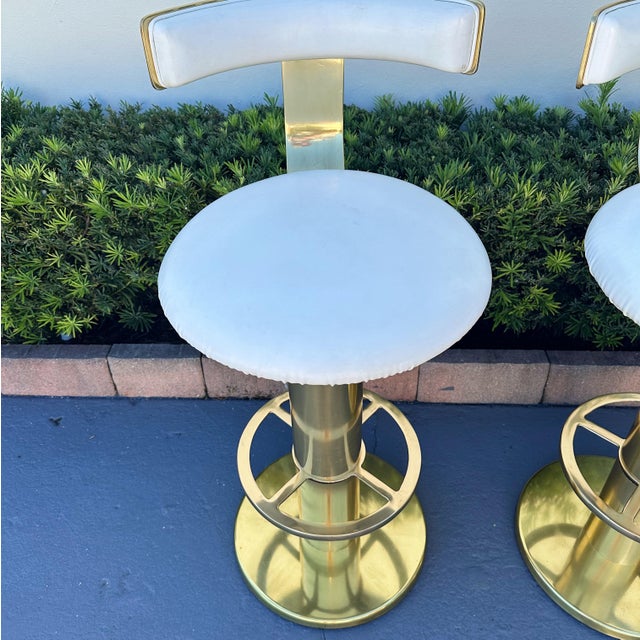 Design for Leisure bar stools from the 1980's Solid brass and white seats.. Label on underside. Very good vintage...