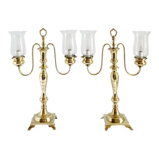 Antique Early 20th Century Electrified Brass Candelabra Lamps With Uricane Glass Shades - A Pair For Sale